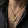Load image into Gallery viewer, Gold plated round dragon coin pendant necklace worn on the neck, lifestyle photo featuring a warm tone finish and strong statement presence.