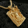 Load image into Gallery viewer, Gold plated Loki pendant necklace on textured volcanic rock, premium close-up showcasing warm reflective shine across the Norse god relief and raised border details.