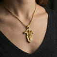Load image into Gallery viewer, Gold plated gothic cross pendant necklace worn on the neck, lifestyle photo featuring warm tone finish and strong statement pendant presence.