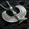 Load image into Gallery viewer, Polished silver winged goddess Isis pendant necklace on textured volcanic rock, crisp macro product photo emphasizing bright reflections, sharp feather detailing, and clean sculpted edges.