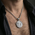 Load image into Gallery viewer, Polished silver dragon medallion pendant necklace worn on the neck, clean lifestyle wear shot capturing bright reflections and the detailed dragon engraving in natural light.
