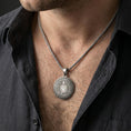 Load image into Gallery viewer, Oxidized Spartan shield medallion pendant necklace worn on the neck, lifestyle framing showing realistic scale and bold vintage contrast against the chest.