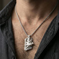 Load image into Gallery viewer, Polished silver Njord Norse sea god pendant necklace worn on the neck, clean lifestyle wear shot capturing bright shine and the detailed Norse figure-and-rune relief in natural light.