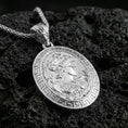 Load image into Gallery viewer, Polished silver Athena coin pendant necklace on textured volcanic rock, crisp macro product photo emphasizing clean edges, sharp engraving, and bright reflective highlights on the relief.
