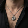 Load image into Gallery viewer, Oxidized Odin and raven medallion pendant necklace worn on the neck, lifestyle framing showing realistic scale and bold vintage contrast against the chest.