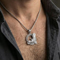 Load image into Gallery viewer, Polished silver Celtic raven knotwork pendant necklace worn on the neck, clean lifestyle wear shot capturing bright shine and the detailed wing-and-knotwork relief in natural light.