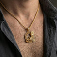 Load image into Gallery viewer, Gold plated Celtic raven knotwork pendant necklace worn on the neck, lifestyle photo featuring warm tone finish and strong statement pendant presence.