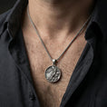 Load image into Gallery viewer, Oxidized koi fish medallion pendant necklace worn on the neck, lifestyle framing showing realistic scale and bold vintage contrast against the chest.