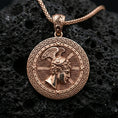 Load image into Gallery viewer, Rose gold plated Perseus coin pendant necklace on textured volcanic rock, centered studio-style close-up showcasing soft rosy glow and intricate Greek mythology portrait detailing.