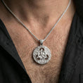 Load image into Gallery viewer, Polished silver Celtic triquetra pendant necklace worn on the neck, clean lifestyle wear shot capturing bright shine and the detailed Trinity knot relief in natural light.