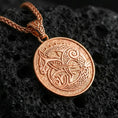 Load image into Gallery viewer, Rose gold plated Urnes style Viking beast pendant necklace on textured volcanic rock, centered studio-style close-up showcasing soft rosy glow and intricate Norse interlace detailing with a refined finish.