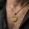 Load image into Gallery viewer, Gold plated Viking deer medallion pendant necklace worn on the neck, lifestyle photo featuring warm tone finish and strong statement talisman presence.