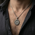 Load image into Gallery viewer, Oxidized sterling silver dragon compass pendant worn on the neck, close-up view with the braided chain and compass rose detail