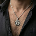 Load image into Gallery viewer, Polished silver dragon ouroboros necklace on the neck, lifestyle shot focusing on the pendant’s circular silhouette