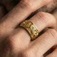 Load image into Gallery viewer, Gold plated koi fish band ring worn on a finger, lifestyle photo featuring warm tone finish and strong statement band presence.