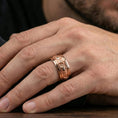 Load image into Gallery viewer, Rose gold plated wolf head band ring worn on a finger, lifestyle wear shot with elegant rosy shine and crisp wolf detailing visible.