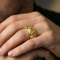Load image into Gallery viewer, Gold plated koi fish and lotus band ring worn on a finger, lifestyle photo featuring warm tone finish and strong statement band presence.