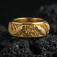 Load image into Gallery viewer, Gold plated koi fish and lotus band ring on textured volcanic rock, premium close-up with warm reflective shine across the koi motifs, lotus petals, and raised ornamental contours.