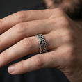 Load image into Gallery viewer, Oxidized Celtic triquetra chain-link ring worn on a finger, lifestyle framing showing realistic scale and bold vintage contrast in a natural hand pose.