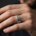 Load image into Gallery viewer, Polished silver Celtic triquetra chain-link ring worn on a finger, clean lifestyle wear shot capturing bright shine and the detailed interlace links in natural light.