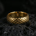 Load image into Gallery viewer, Gold plated woven texture band ring on volcanic stone, premium close-up highlighting warm gold tone across the braided grid pattern and smooth edges.