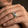 Load image into Gallery viewer, Polished silver lovers face ring worn on a finger, lifestyle image capturing reflective finish and sharp portrait relief for a clean modern look.