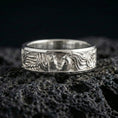Load image into Gallery viewer, Polished silver lovers face ring on volcanic stone, clean product photo emphasizing bright shine and crisp relief details in the faces and hair.