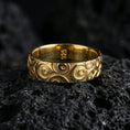 Load image into Gallery viewer, Gold plated geometric circle pattern ring on volcanic stone, premium macro photo showing warm gold tone across the repeating concentric design.