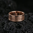 Load image into Gallery viewer, Rose gold plated Greek key spinner ring on volcanic stone, elegant macro shot capturing soft rose reflections on the Greek key band and brushed center texture.