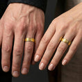 Load image into Gallery viewer, Gold plated hammered texture band ring worn on a finger, lifestyle wear shot highlighting luxury gold tone, textured craftsmanship, and clean silhouette.