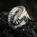 Load image into Gallery viewer, Polished silver koi fish wrap ring on volcanic stone, macro shot emphasizing smooth reflective surfaces, crisp sculpting, and clean scale definition.