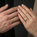Load image into Gallery viewer, Gold plated Celtic knot band ring worn on the finger, lifestyle photo emphasizing luxury gold tone, timeless knot symbolism, and gift-ready appeal.