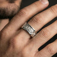 Load image into Gallery viewer, Polished silver spinner ring worn on the finger, lifestyle shot highlighting bright shine, comfortable band profile, and modern unisex wear appeal.