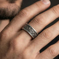 Load image into Gallery viewer, Oxidized sterling silver spinner ring worn on the finger, lifestyle image focusing on bold vintage depth, tactile spinning function, and everyday statement styling.