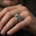 Load image into Gallery viewer, Oxidized sterling silver lion head ring worn on the finger, lifestyle image focusing on bold statement presence, antique depth, and masculine styling.