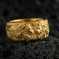 Load image into Gallery viewer, Gold plated lion head ring on volcanic stone, premium macro shot capturing warm gold tone across the lion relief and high-contrast engraved background.