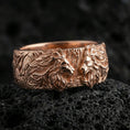 Load image into Gallery viewer, Rose gold plated lion head ring on volcanic stone, refined macro close-up showcasing soft rose sheen, dimensional lion heads, and detailed mane carving.