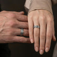 Load image into Gallery viewer, Oxidized sterling silver pebble texture band ring worn on the finger, lifestyle image focusing on rugged minimalist style, matte depth, and everyday wear presence.
