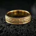 Load image into Gallery viewer, Gold plated bark texture band ring on volcanic stone, premium macro shot capturing warm gold tone across the rustic bark pattern with sharp, modern silhouette.