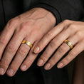 Load image into Gallery viewer, Gold plated bark texture band ring worn on the finger, lifestyle photo emphasizing luxury warmth, unisex wedding band appeal, and bold organic texture.