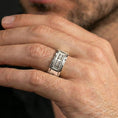 Load image into Gallery viewer, Polished silver sci-fi band ring worn on the finger, lifestyle shot highlighting sleek shine, geometric structure, and everyday wear presence.