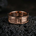 Load image into Gallery viewer, Rose gold plated sci-fi band ring on volcanic stone, refined macro close-up showing soft rose sheen, precision grooves, and a bold unisex silhouette.