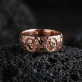 Load image into Gallery viewer, Rose gold plated Greek sculpture ring on volcanic stone, refined macro close-up showing soft rose warmth, detailed cameo faces, and luxury finish depth.