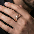 Load image into Gallery viewer, Rose gold plated Greek sculpture ring worn on the finger, lifestyle image highlighting elegant rose tone, dimensional portrait relief, and premium modern styling.