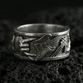 Load image into Gallery viewer, Oxidized sterling silver guitar ring on volcanic stone, macro close-up highlighting the raised electric guitar and hand detail with deep vintage patina.