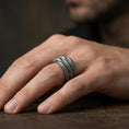 Load image into Gallery viewer, Oxidized sterling silver layered studded band ring worn on the finger, lifestyle image showing rugged industrial character and bold everyday presence.