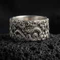 Load image into Gallery viewer, Oxidized sterling silver dragon cloud band ring on volcanic stone, macro close-up highlighting raised swirling clouds and detailed dragon scales.