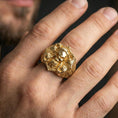 Load image into Gallery viewer, Gold plated skull signet ring on finger, lifestyle image emphasizing the bright finish and intricate Celtic pattern engraving
