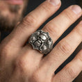 Load image into Gallery viewer, Oxidized skull signet ring with Celtic knot engraving worn on finger, lifestyle close-up showing bold gothic heritage style