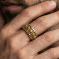 Load image into Gallery viewer, Skull motif sterling silver band ring worn on a finger, gold plated look for a bold statement while keeping the skull texture clearly visible.